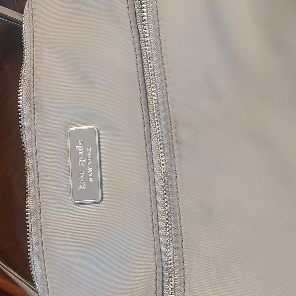 A spacious gray Kate Spade crossbody bag.